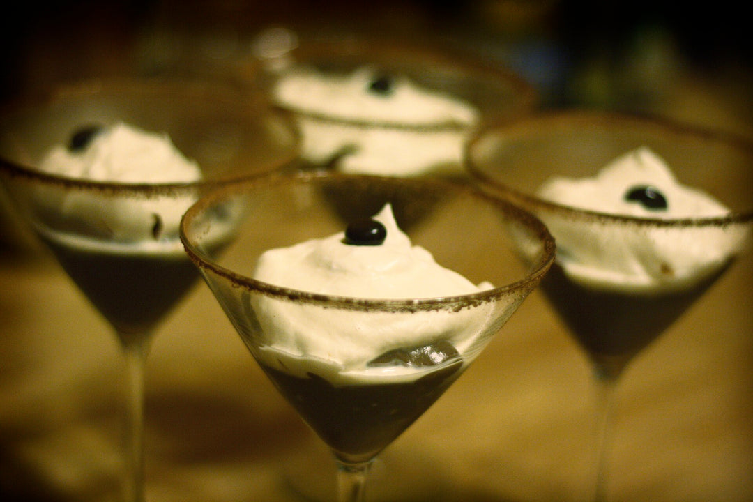 Chocolate pudding in glasses topped with cream